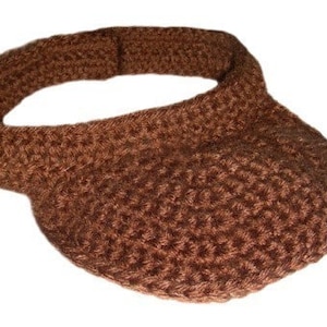 May include: A brown crocheted visor with a wide brim.