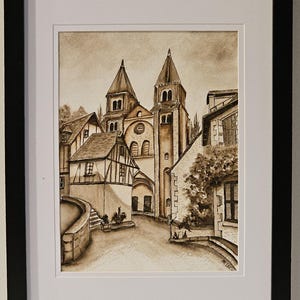 May include: A sepia toned watercolor painting of a European village with two tall church towers in the background. The buildings are painted in shades of brown and beige, with a stone wall and steps in the foreground.