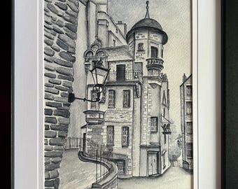 May include: Black and white watercolor painting of a narrow street with a tall building with a turret and a lamppost. The building has many windows and a balcony. The street is cobblestone and curves around the building.