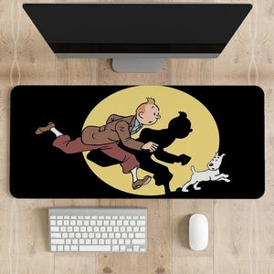 May include: A black and yellow desk mat featuring a cartoon illustration of a man running with a dog. The man is wearing a brown jacket, red trousers, and a blue shirt. The dog is white with black spots.