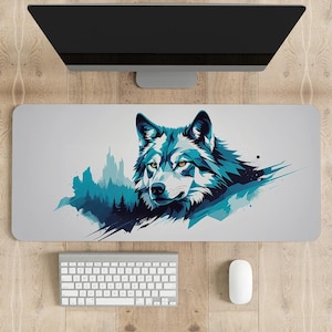 May include: A gray desk mat with a blue and white wolf illustration. The wolf is looking directly at the viewer. The background of the illustration is a blue and green watercolor-style forest.