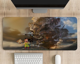 May include: A rectangular mouse mat with a detailed illustration of a moving castle and characters from the animated film. The design includes a keyboard, mouse, and computer monitor.
