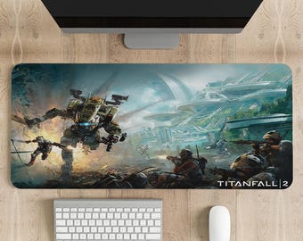 May include: A gaming mouse pad featuring a futuristic cityscape with a large robot in the foreground. The text "TITANFALL 2" is in the bottom right corner.