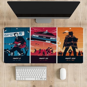 May include: A three-panel desk mat featuring scenes from the Back to the Future movie trilogy. The first panel shows a musician playing a guitar with the text "Part I Nov 12 1955". The second panel shows a flying DeLorean time machine with the text "Part II Oct 21 2015". The third panel shows a cowboy with the text "Part III Jan 01 1885".