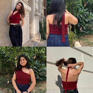 May include: A burgundy halter top with a unique asymmetrical design. The top is made of a knitted material and features a strap that ties around the neck. The top is paired with black pants and blue jeans.
