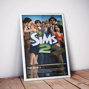 May include: A framed poster for the video game The Sims 2, featuring a group of diverse digital characters in the foreground and the large blue and green logo in the center. The bottom section includes the game title, descriptive text, and developer.