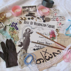 May include: A collection of vintage ephemera, including a playbill for "Rose of Washington Square", a cross, a pair of gloves, lace trim, ribbons, and a pencil.