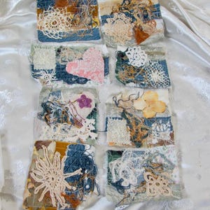 May include: Eight rectangular fabric collages featuring layered denim, lace doilies, and assorted textile scraps. Each piece incorporates frayed threads, embroidered floral motifs, and textured patches in shades of blue, white, and tan.