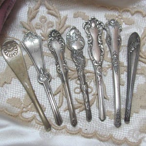 May include: Seven antique silver teaspoons with ornate handles. The spoons have a vintage look and are perfect for adding a touch of elegance to any table setting.