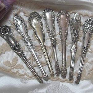 May include: Eight antique silver spoons with ornate designs. The spoons have a variety of patterns and are in excellent condition.