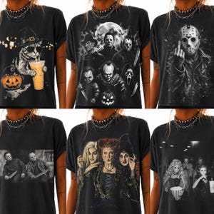 May include: A collection of six black short-sleeve t-shirts featuring various horror and Halloween-themed graphic prints, including a cat in a witch hat, a group of classic horror movie villains, a hockey mask character, and a trio of witches.