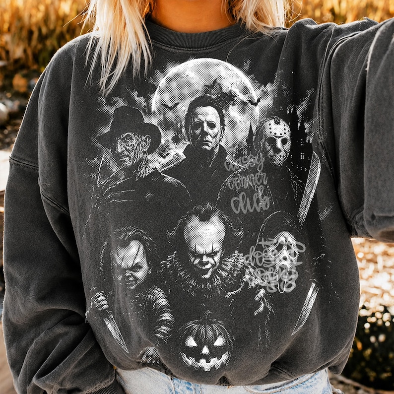 May include: A charcoal gray crewneck sweatshirt featuring a black and white graphic print of six iconic horror movie characters arranged around a large full moon, with the text "spooky corner club" and "do not disturb" printed in a script font.