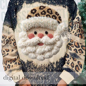 Puede incluir: Una sudadera de manga larga con un estampado de leopardo desteñido en negro y beige. El centro muestra un gráfico texturizado en tres dimensiones de una cara de Papá Noel con barba blanca esponjosa y un gorro de leopardo.