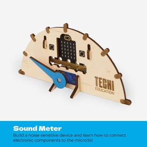 May include: A semi-circular light wood sound meter device featuring a blue plastic pointer, a black micro:bit controller board with a dot matrix display, and the text TECHI EDUCATION laser-etched on the front surface with small wooden pegs.