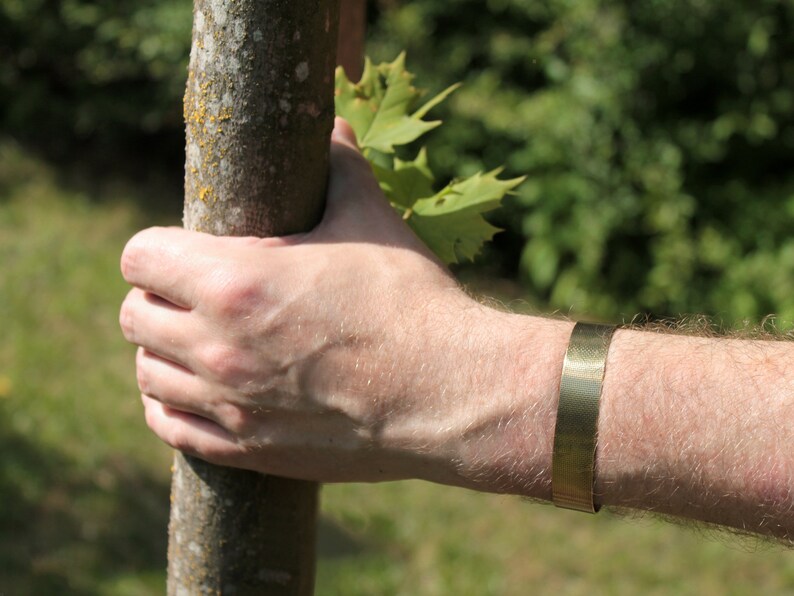 simple brass bracelet on hand