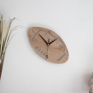 Horloge murale Ballon de Rugby unique en stratifié - Larg 17 cm - haut 30 cm - Mécanisme silencieux.