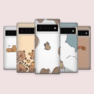 May include: Set of six phone cases featuring different illustrations of capybaras. The cases are in various colors, including white, beige, and blue. Each case has a different design, including capybaras with fruit, capybaras in a cloud, and capybaras with hearts.