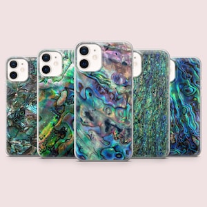 May include: Five mobile phone cases with an iridescent abalone shell design. The cases feature a mix of blues, greens, and purples, creating a unique pattern. The cases are arranged in a row, showcasing the variety of designs.