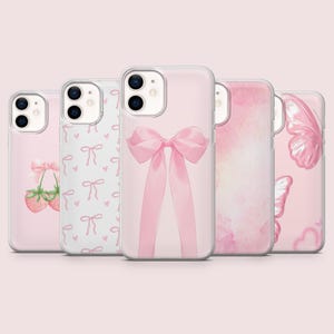 May include: Set of four pink iPhone cases with different designs. One case features a pink bow, another has a pink and white strawberry pattern, another has a pink watercolor design, and the last one has a pink butterfly design.