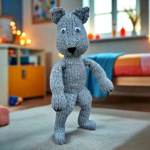 May include: A gray knitted kangaroo toy with googly eyes, black nose, and paws. The handmade stuffed animal is standing on a light-colored rug. The kangaroo has a classic design and is in a child's bedroom.