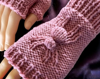 May include: A pair of pink knitted fingerless gloves with a pom-pom detail on each cuff.