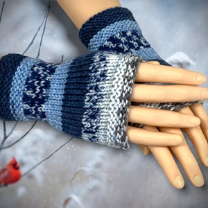 May include: Blue and white striped fingerless gloves with a knitted pattern. The gloves are made from a soft, warm yarn.