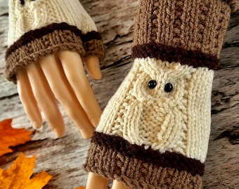 May include: A pair of brown and white knitted fingerless gloves with an owl design. The gloves have a brown cuff and a white owl face with black eyes.
