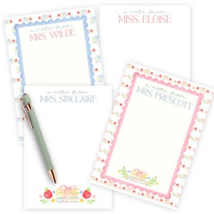 Puede incluir: Cuatro blocs de notas rectangulares con papel blanco y bordes decorativos. Los blocs incluyen el texto a note from seguido de los nombres Mrs. Wilde, Miss. Eloise, Mrs. Sinclaire y Mrs. Prescott. Se incluye un bolígrafo verde salvia con detalles dorados.