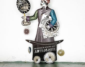 May include: A whimsical paper cutout of a Victorian-era astrologer. The figure, dressed in a long coat and hat, holds a globe and papers with astrological charts. The base is a top hat with the text "Professor Know-All Astrologer."