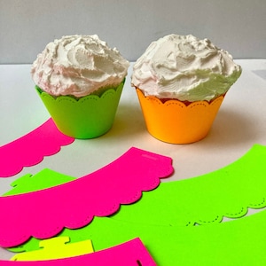 May include: Neon green and orange cupcake liners with white frosting on top.  There are also several neon green and pink cupcake liners with scalloped edges.