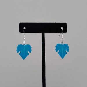 May include: A pair of silver dangle earrings with blue leaf-shaped charms.