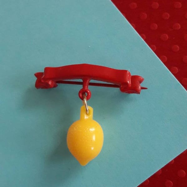 Pass the Fruit-Bowl! Red Celluloid Banner Pin with Yellow Lemon Charm