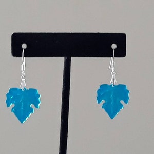 May include: A pair of silver dangle earrings with blue leaf-shaped charms.