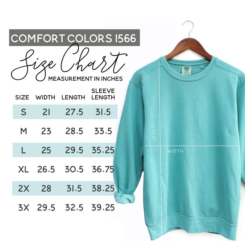 May include: A turquoise Comfort Colors sweatshirt hangs on a wooden hanger. A size chart in inches is displayed, showing measurements for width, length, and sleeve length for sizes S to 3X. The sweatshirt's length and width are indicated with white lines.