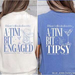 Pu&ograve; includere: T-shirt avorio e blu jeans con testo e grafica. La maglietta avorio dice "Olivia's Bachelorette, A Tini Bit Engaged, Nashville, TN, June 2025" con cappello da cowboy, stivali e bicchiere da martini. La maglietta blu dice "Olivia's Bachelorette, A Tini Bit Tipsy, Nashville, TN, June 2025".