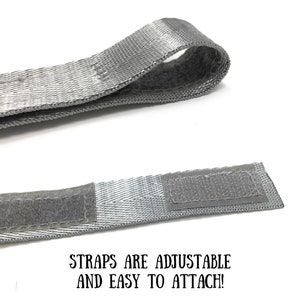 May include: Two close-up images of a gray adjustable strap with hook and loop fasteners. The text "STRAPS ARE ADJUSTABLE AND EASY TO ATTACH!" is printed below the images.