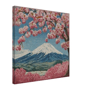 May include: A mosaic art piece depicting Mount Fuji with a snow-capped peak, set against a blue sky. Pink cherry blossoms frame the mountain and a foreground of pink foliage. The artwork is a square canvas.