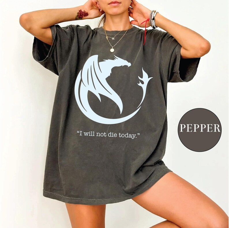 a woman wearing a t - shirt with a dragon on it