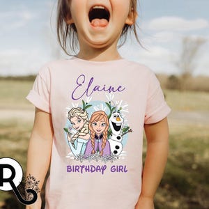 a little girl with her mouth open wearing a pink shirt