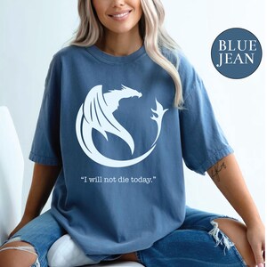 a woman sitting on a toilet wearing a blue jean shirt
