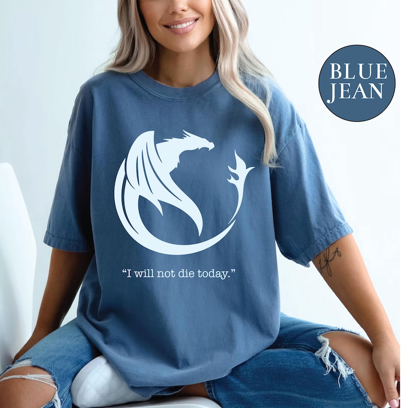 a woman sitting on a toilet wearing a blue jean shirt