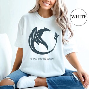 a woman wearing a white t - shirt with a dragon on it
