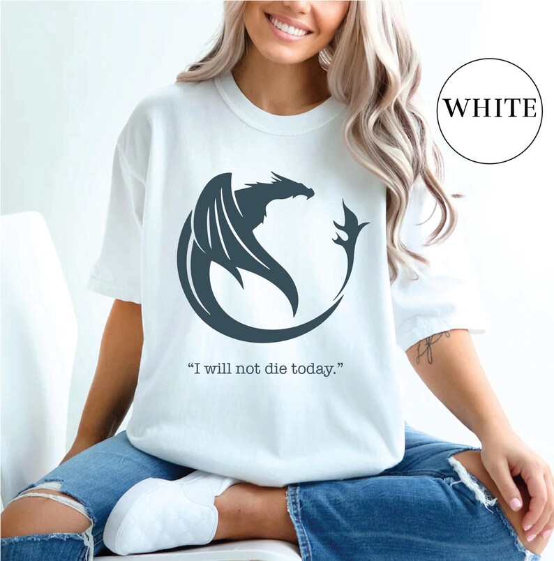 a woman wearing a white t - shirt with a dragon on it