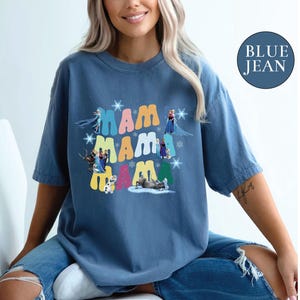a woman sitting on a chair wearing a blue jean shirt
