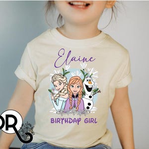 a little girl wearing a frozen princess shirt