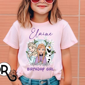 a little girl wearing a frozen princess shirt