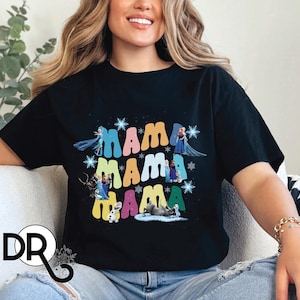 a woman sitting on a couch wearing a black mama mama shirt
