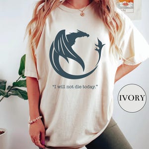 a woman wearing a t - shirt with a dragon on it