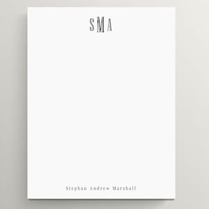 May include: White notepad with the initials "SMA" printed at the top and the name "Stephan Andrew Marshall" printed at the bottom.