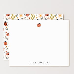 May include: White stationery set featuring a ladybug design. The stationery includes a blank card with a single ladybug illustration and the name "MOLLY LOVVORN" printed at the bottom. The envelope has a floral and ladybug pattern.